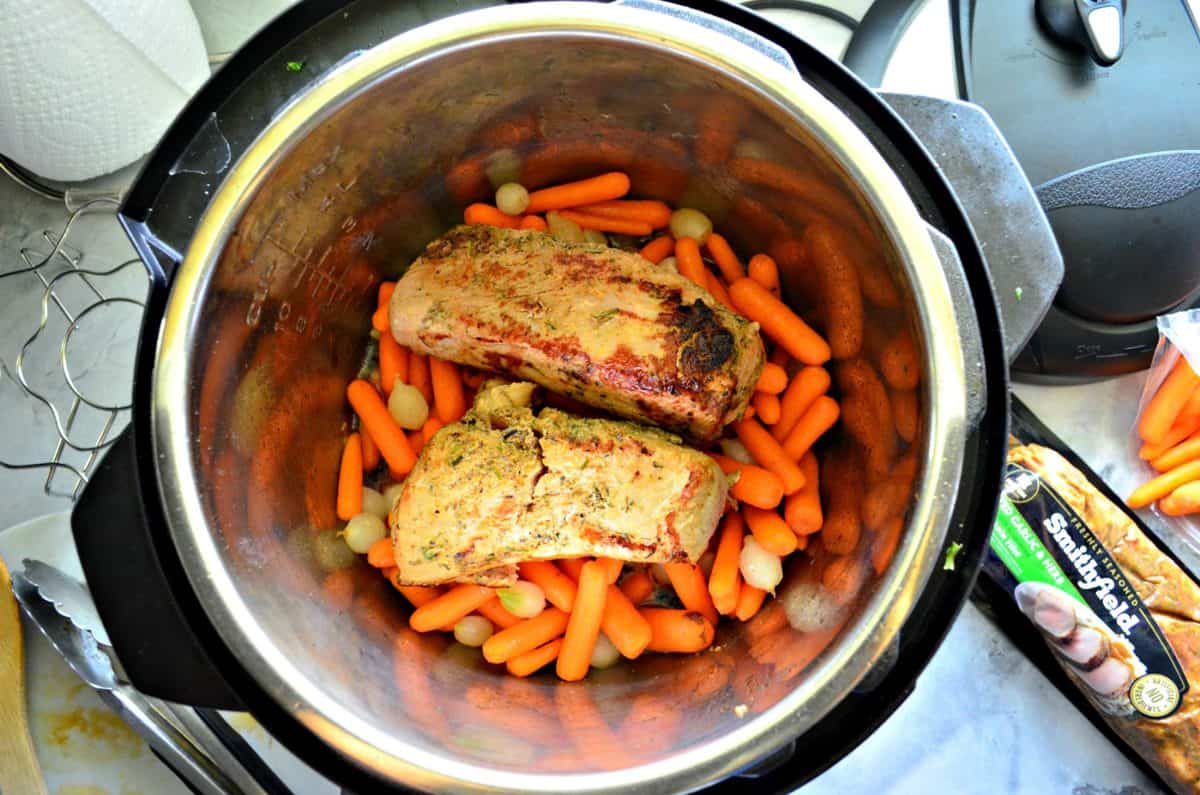 top view of Garlic and Herb Pork Tenderloin with Carrots and Pearl Onions in instant pot.