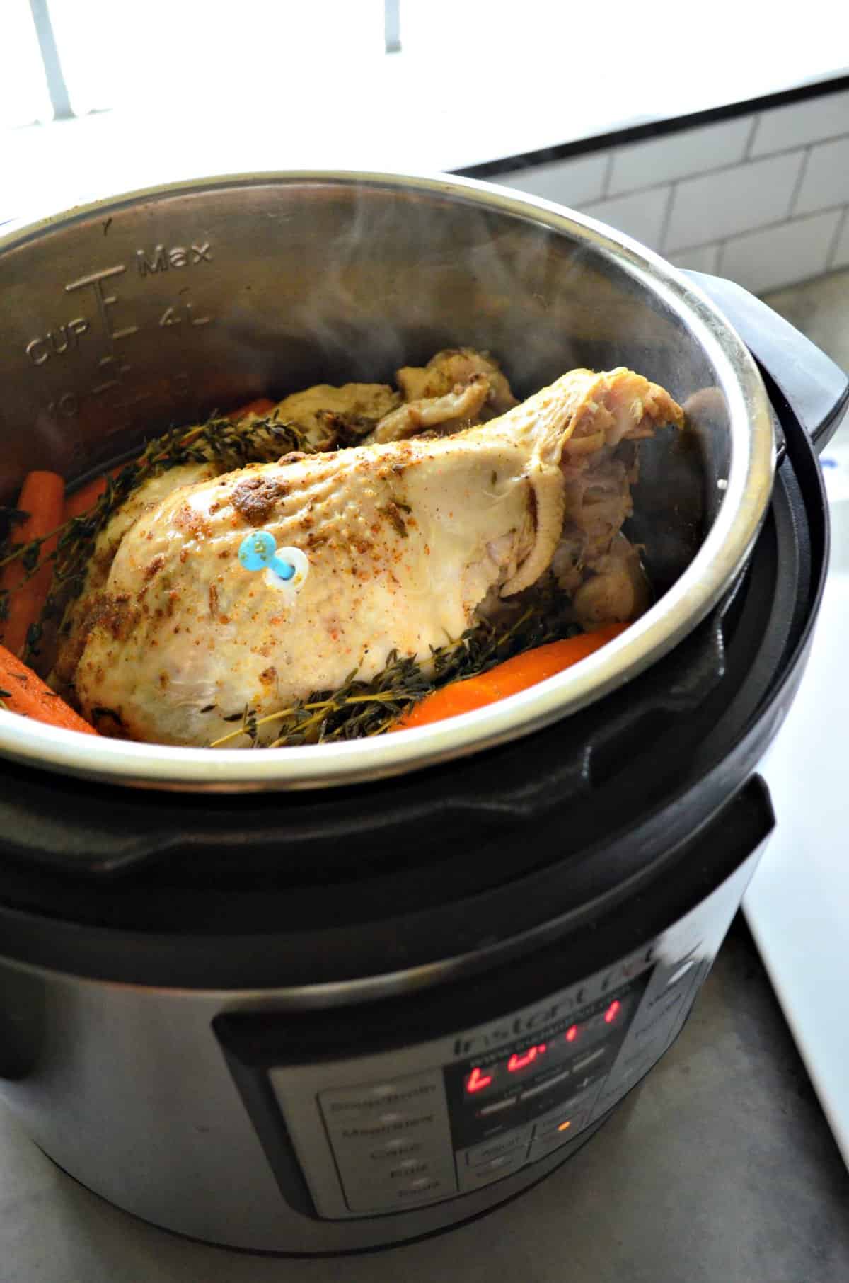 Turkey Breast in an instant pot with herbs and carrots.