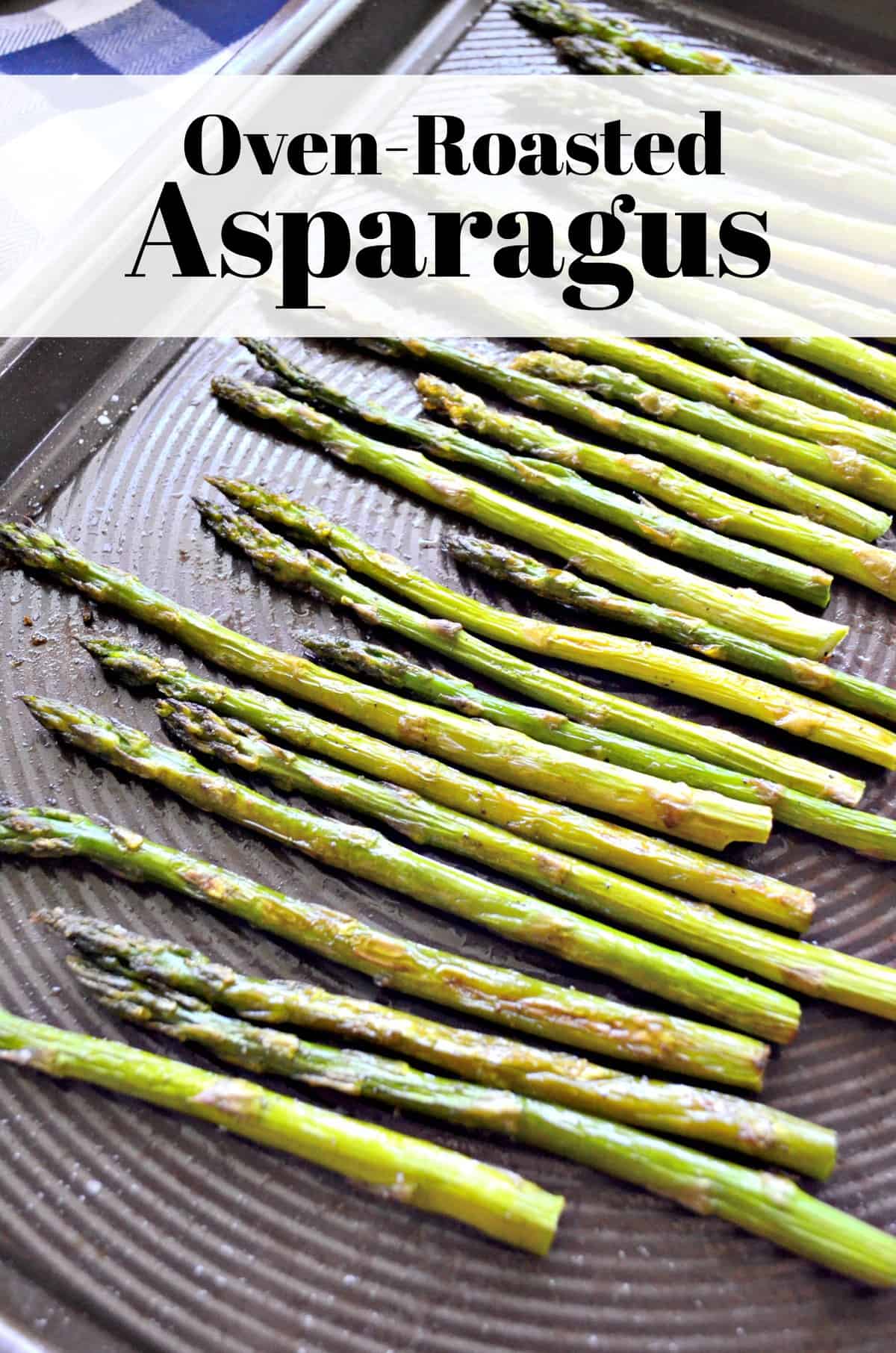 Top view of roasted asparagus on sheet pan sprinkled with salt and title text.