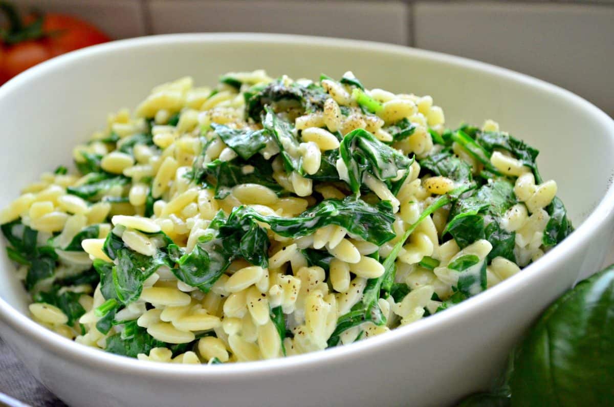 close up side view of Creamy Parmesan Orzo with Spinach in bowl.