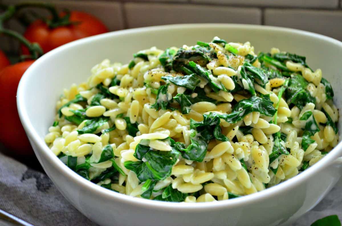 Side view of Creamy Parmesan Orzo with Spinach in bowl.