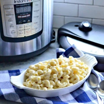 White oval dish filled with macaroni and cheese with Instant Pot in the background.
