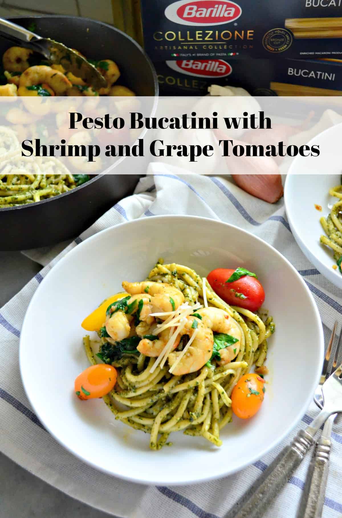 bowl of bucatini with pesto, grape tomatoes, shrimp, basil, and cheese on tablecloth with title text.