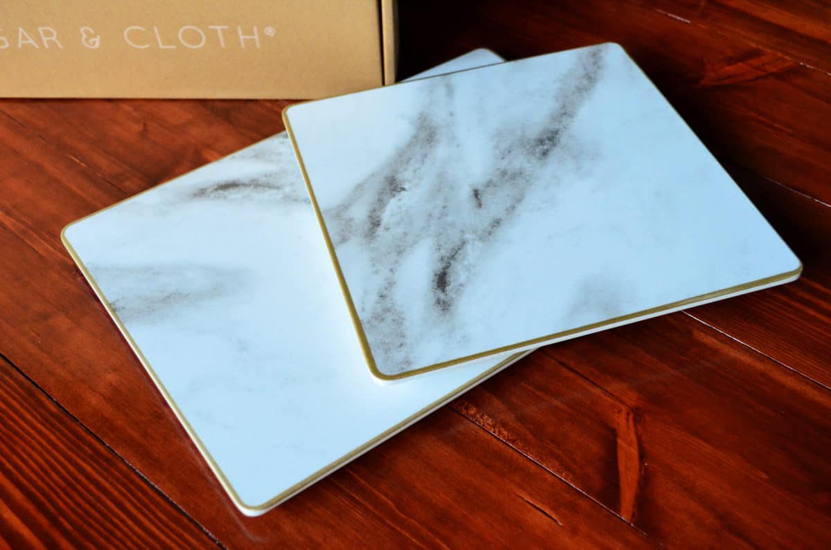 Sugar & Cloth Rectangular Marble Melamine Serving Trays on hardwood floor.