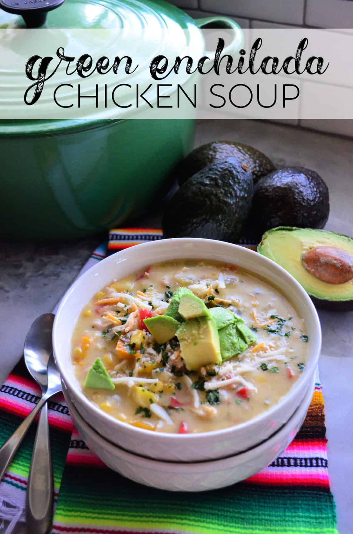 Green Enchilada Chicken Soup in bowl topped with cheese and avocado with title text.