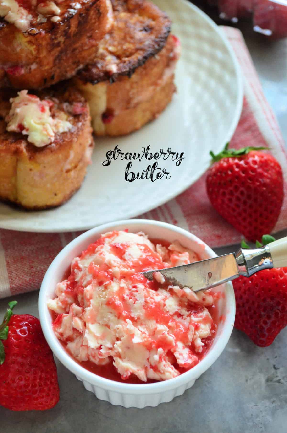 small bowl of chopped strawberries mixed with butter next to platter of french toast with title text.