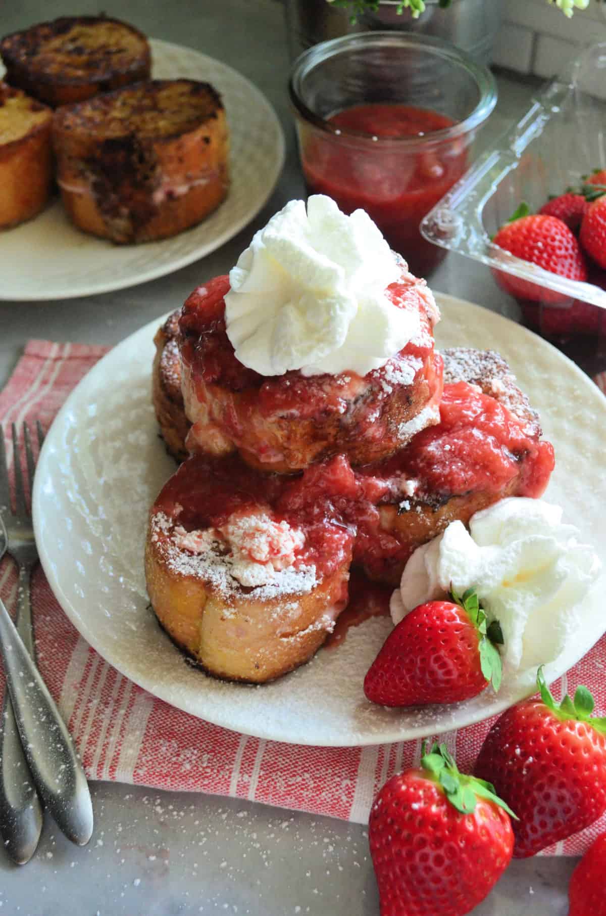 Strawberry Cream Cheese Stuffed French Toast on red striped placemat.