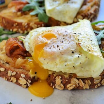 close up of Bacon, Egg, and Caramelized Onion Hummus Toast