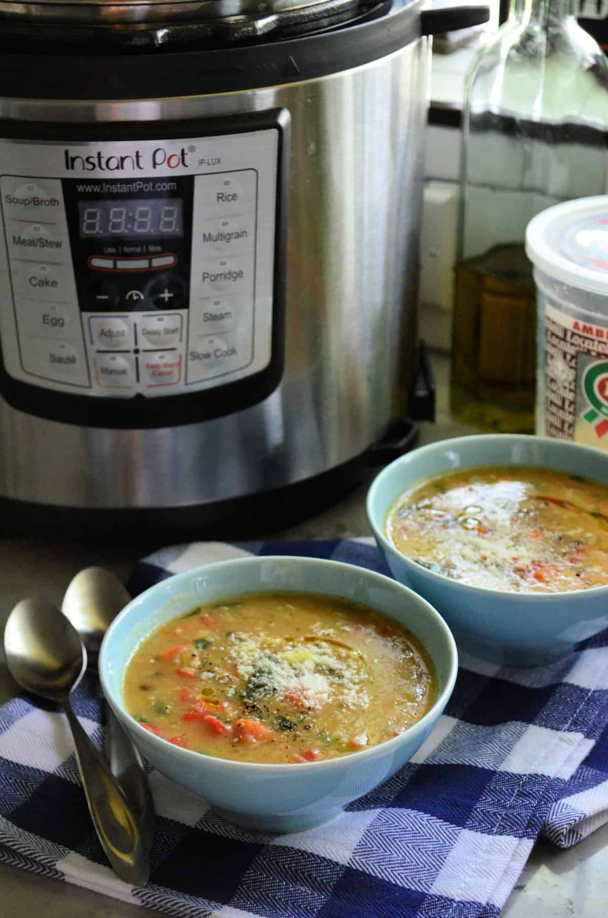 2 bowls of vegetable soup topped with parmesan cheese in front of instant pot with title text.