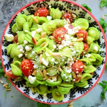 bright green orichette pasta with grape tomatoes, cheese, and pine nuts.