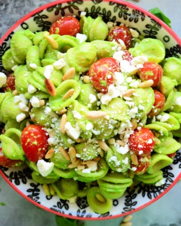 bright green orichette pasta with grape tomatoes, cheese, and pine nuts.