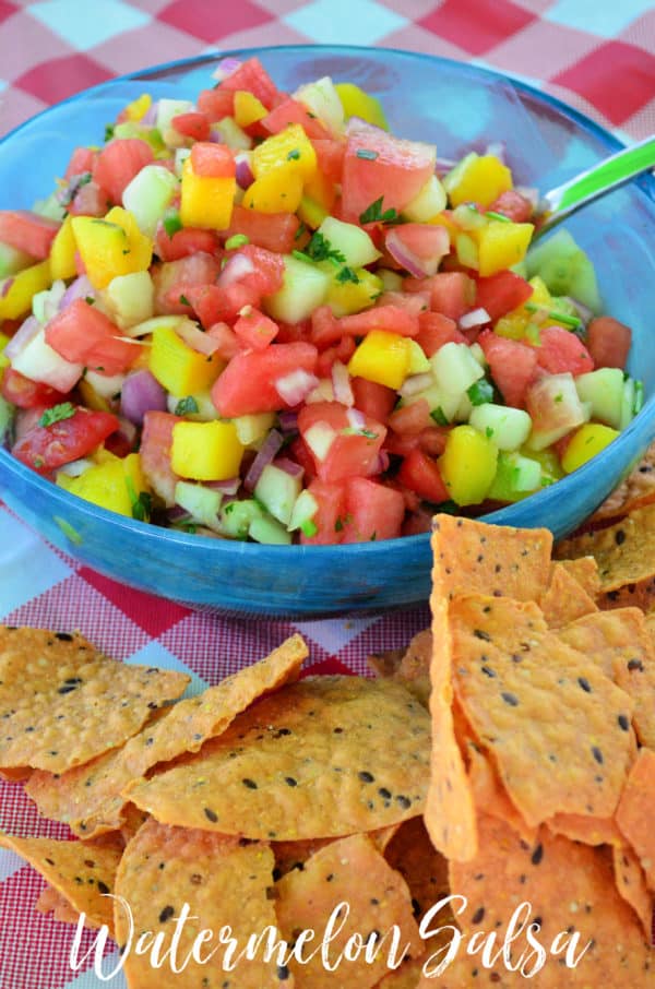 Bowl of diced watermelon, mango, onion, cilantro next to pile of corn chips with pinterest title text.