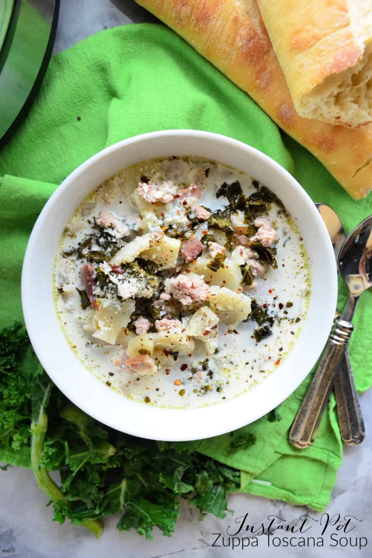 Top View Bowl of creamy soup with potatoes and herbs on top.