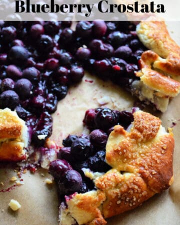 Close up of cooked blueberries in golden brown pastry crust with pinterest title text.