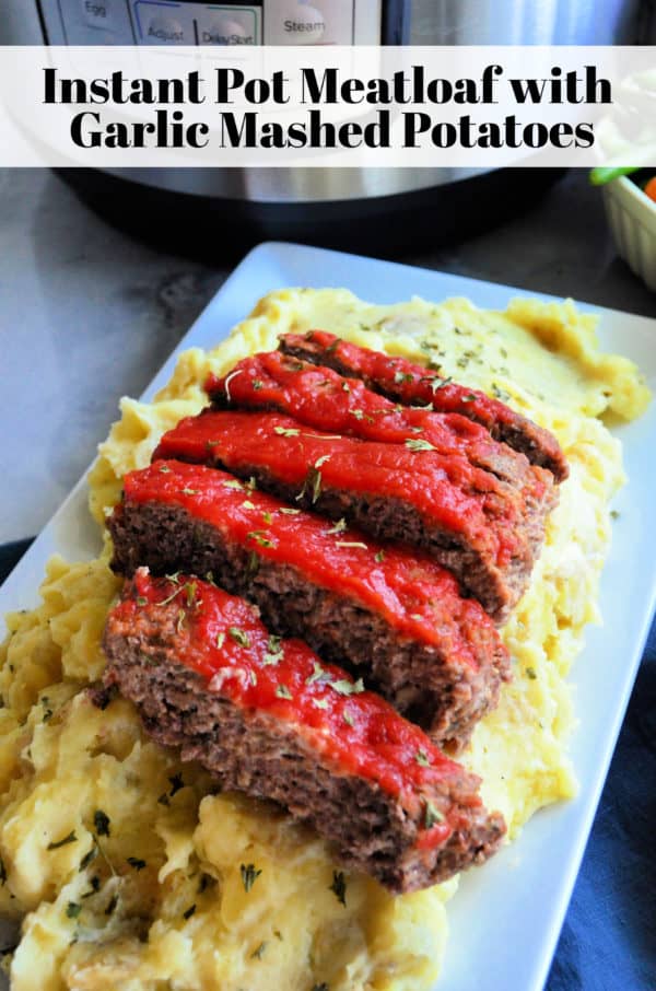 Platter of Golden herbed mashed potatoes topped with meatloaf dripping with red sauce. Pinterest title text.