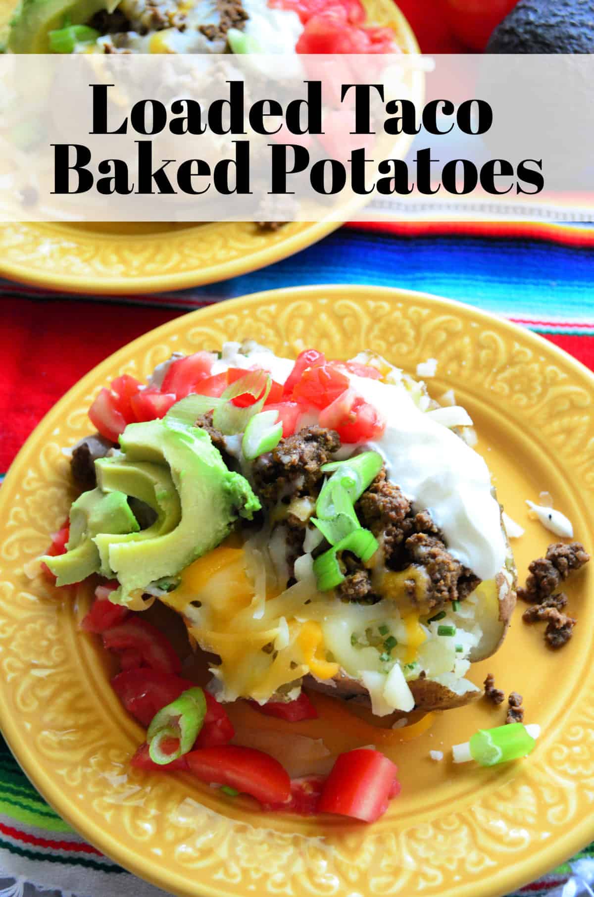 Top view of split baked potato with sour cream, meat, tomato, cheese, avocado with title text.