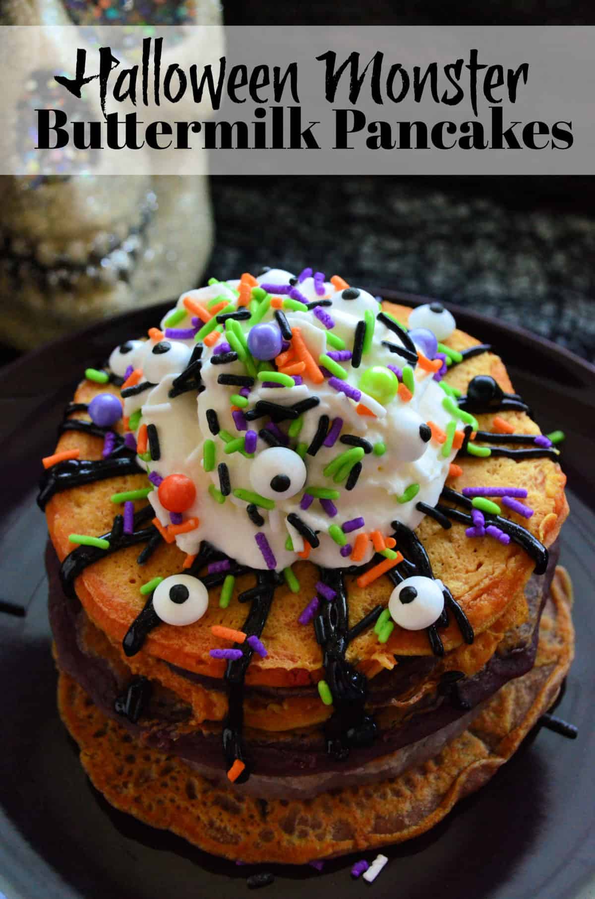 Stacked orange pancakes topped with whipped cream, sprinkles, and candy eyeballs with title text.