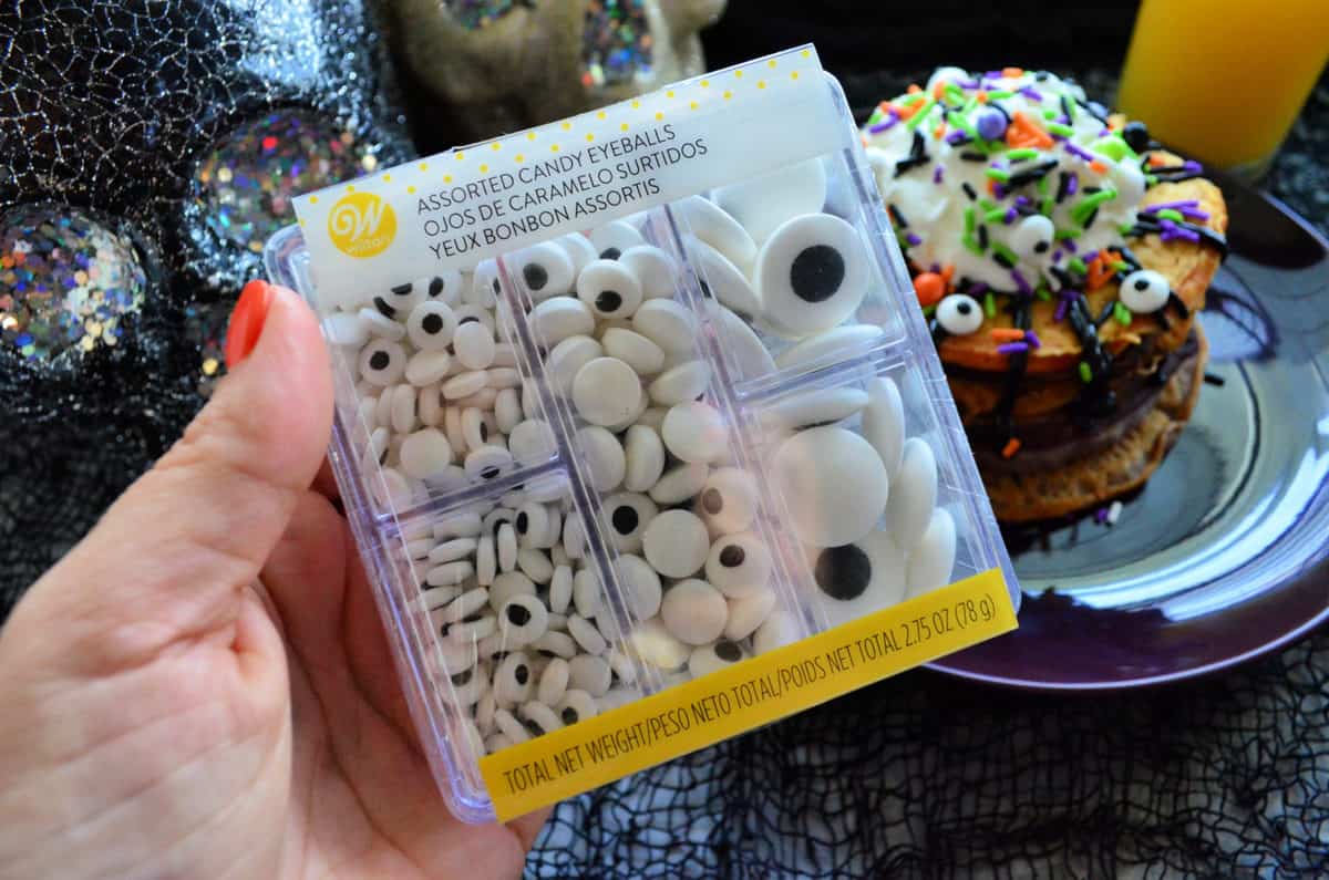 Wilton Candy Eyeballs in package with monster pancakes in background.