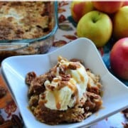 Bowl of cake topped with ice cream, pecans and drizzled caramel. Pinterest title text.