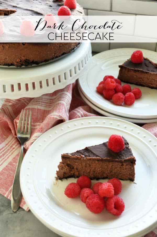 Slice of plated Dark Chocolate Raspberry Cheesecake in front of remaining cheesecake with pinterest title text.