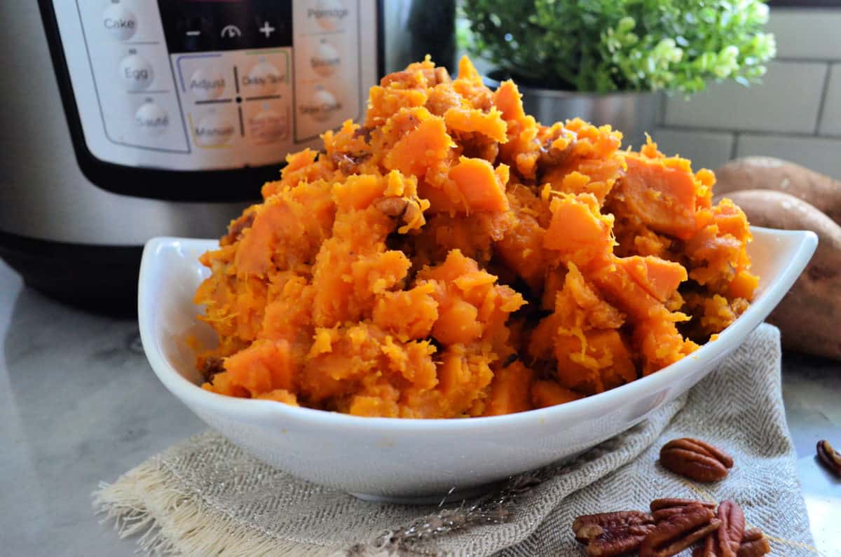 Close up of Bowl of Candied Sweet potatoes in front of Instant Pot.