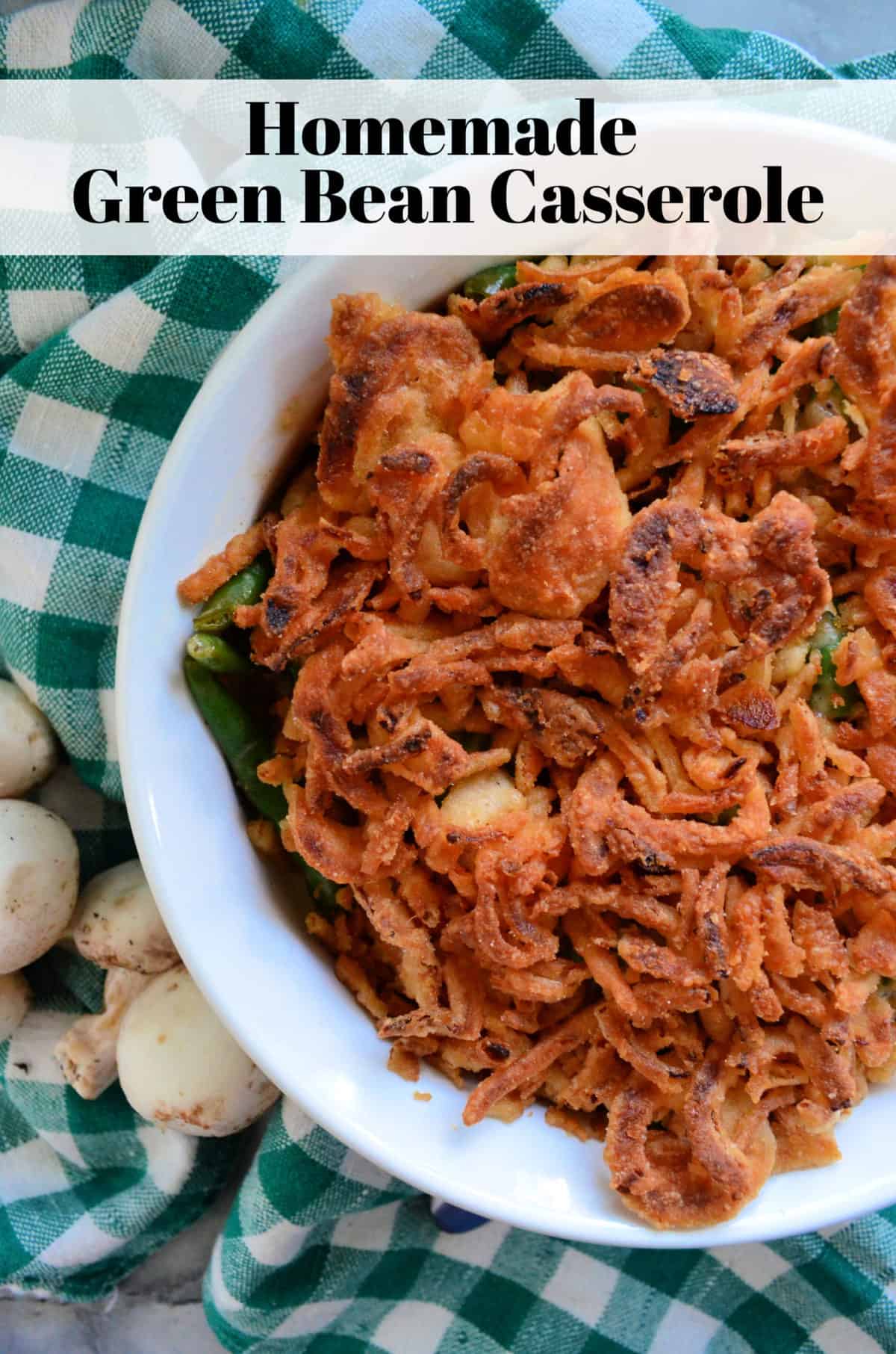 Top view green beens in casserole dish topped with crispy french fried onions with title text.