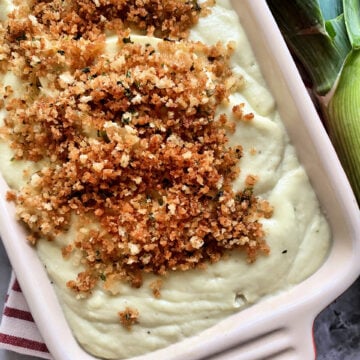Cauliflower-Leek Puree in a baking dish with panko breadcrumbs on top