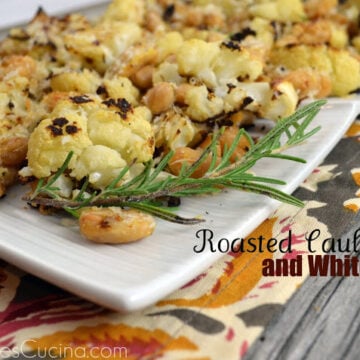 Plated Roasted Cauliflower and White Beans garnished with rosemary.