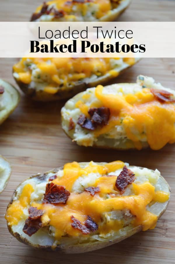Multiple Loaded Twice Baked Potatoes on cutting board with pinterest title text.