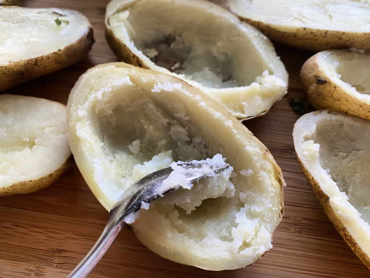 Loaded Twice baked potatoes with spoon in them and insides missing prior to loading.