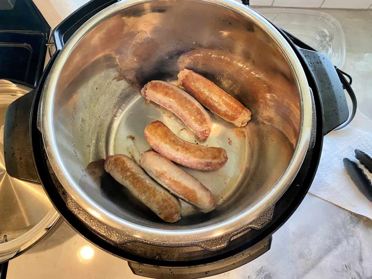Top view of italian sausages browning in Instant Pot.