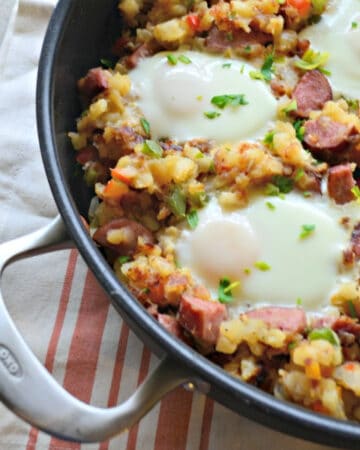 Skillet with potatoes, sausage and over easy eggs.