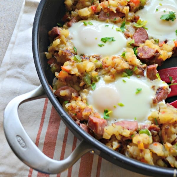 Skillet with potatoes, sausage and over easy eggs.
