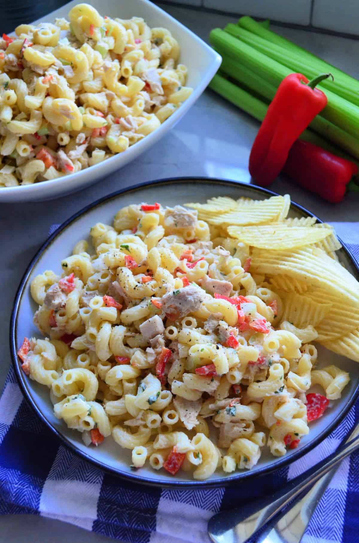 plated Macaroni and Tuna Salad with Potato Chips near celery, bell pepper, and remaining salad.