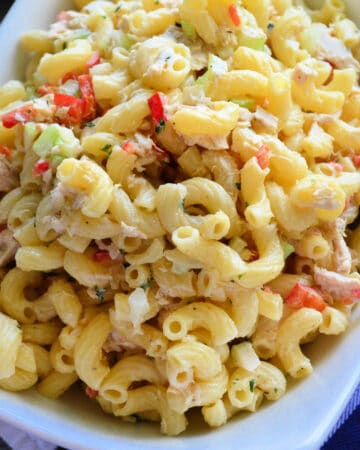 White rectangular bowl with macaroni, tuna, and vegetables.