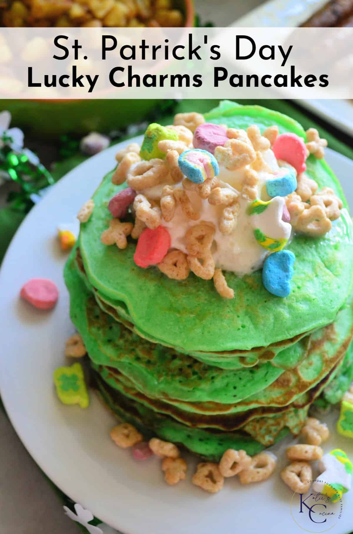 top view of stacked green pancakes topped with melted marshmallow and lucky charms with title text.