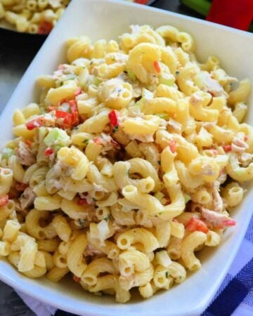 White rectangular bowl with macaroni, tuna, and vegetables.