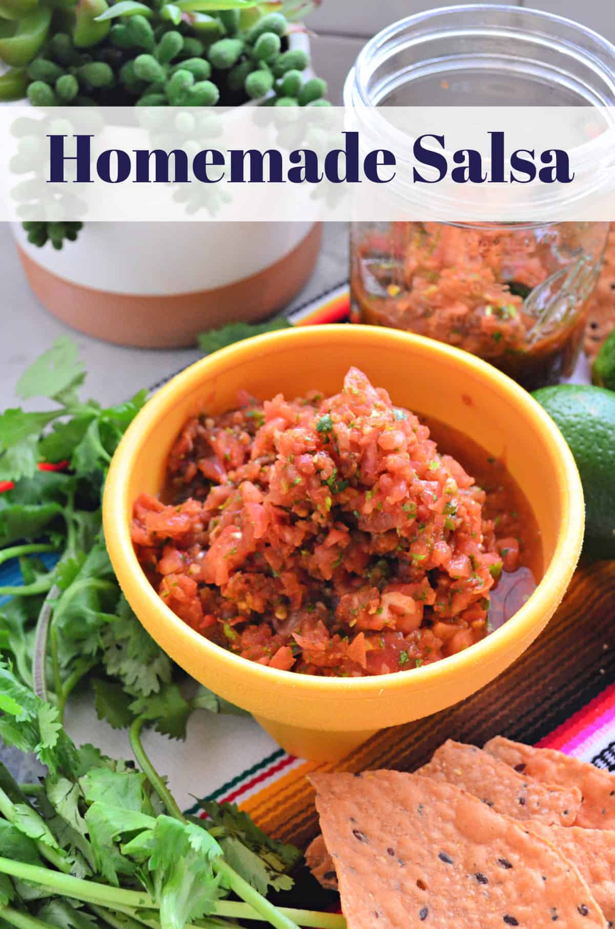 Homemade salsa in a yellow bowl fresh herbs and chips around with text on the photo. 