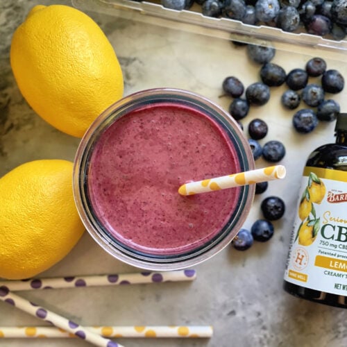Blueberry Lemon Smoothie in a glass with Barleans CBD and fresh fruit.