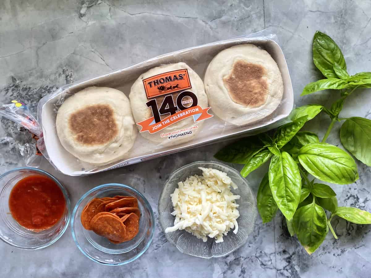 English Muffins, Tomato Sauce, Pepperoni, Mozzarella Cheese, and Basil to make Toaster Oven English Muffin Pizzas.