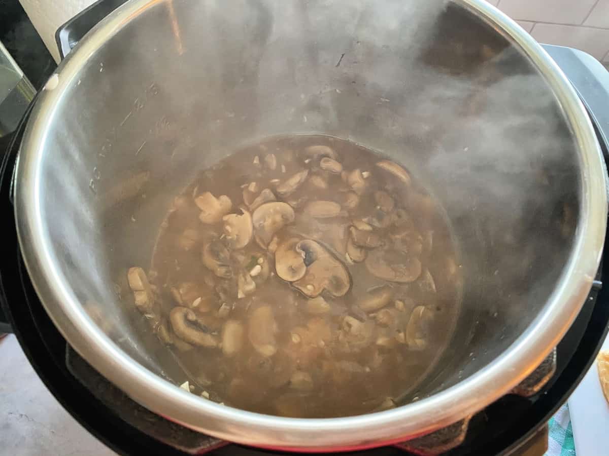 Top view of Marsala mushroom sauce in the Instant Pot with steam.