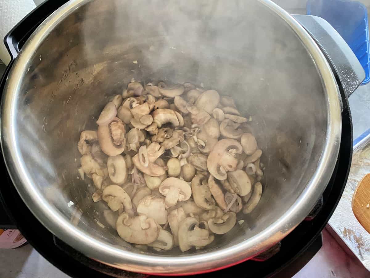 Top view of Mushrooms and shallots simmering in the Instant Pot.
