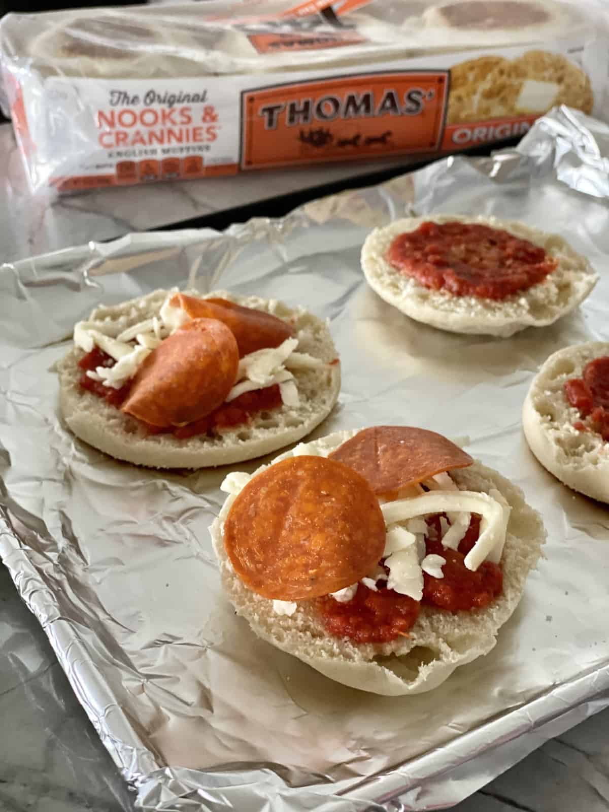 Toaster Oven English Muffin Pizzas topped with sauce, cheese, & pepperoni