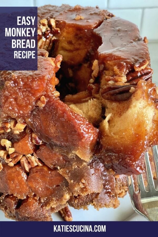 Fork pulling pieces of sweet bread apart on a white plate with text.