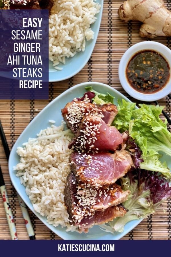 Top view of sliced seared tuna on rice and salad on a blue plate with text.