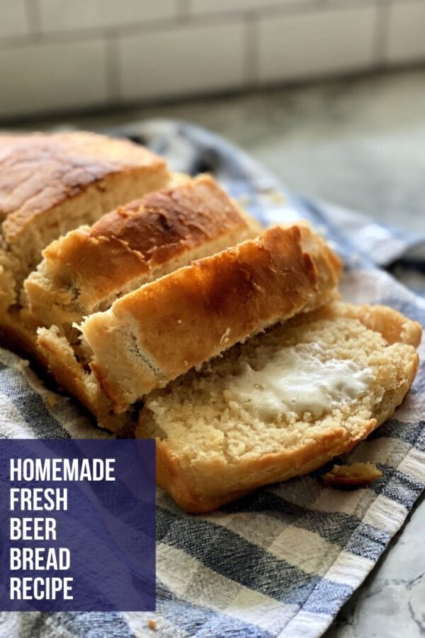 sliced beer bread on a blue and white checkered dish towel.