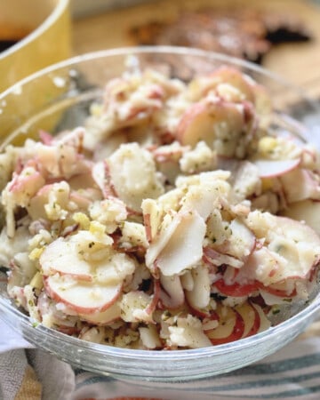 Glass bowl filled with potato salad.