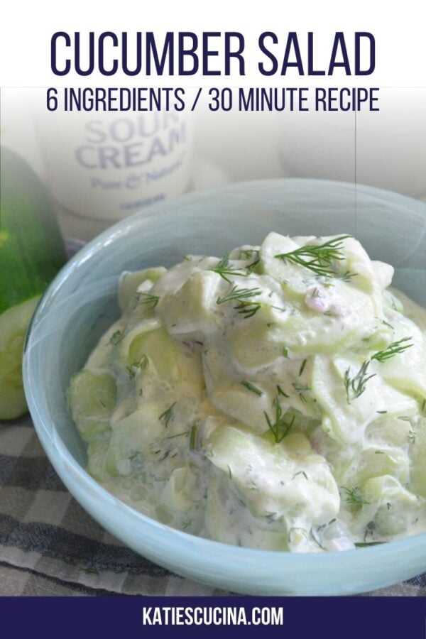 Thinly sliced cucumbers in a white cream sauce in a blue bowl with text on image for Pinterest.