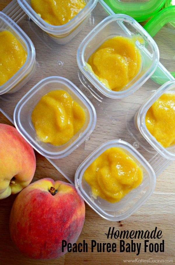 Top view of orange puree in a small square containers on a wood countertop next to peaches.