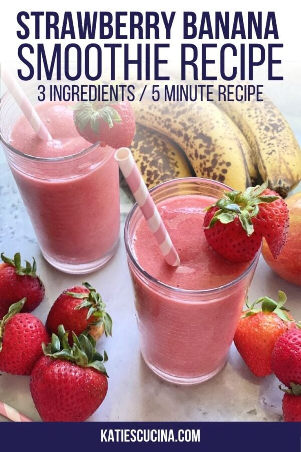 Top view of two pink smoothies in glasses with fruit on counter.